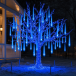 Meteor shower tube lights glowing outdoors along a porch or tree line