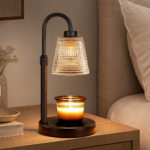 Candle warmer lamp glowing on a calm bedroom or living-room side table