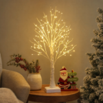 Lighted birch tree decorations glowing in a warm interior corner
