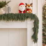 Artificial cedar Christmas garland styled across a warm neutral mantel
